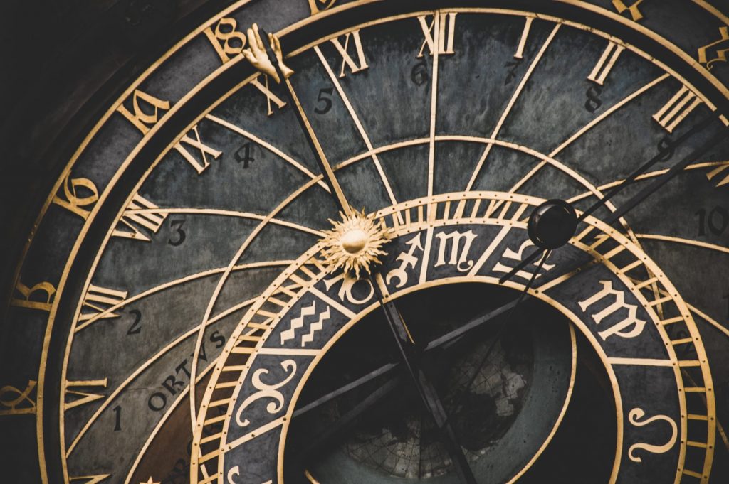 Close up of elaborate black and gold clock.